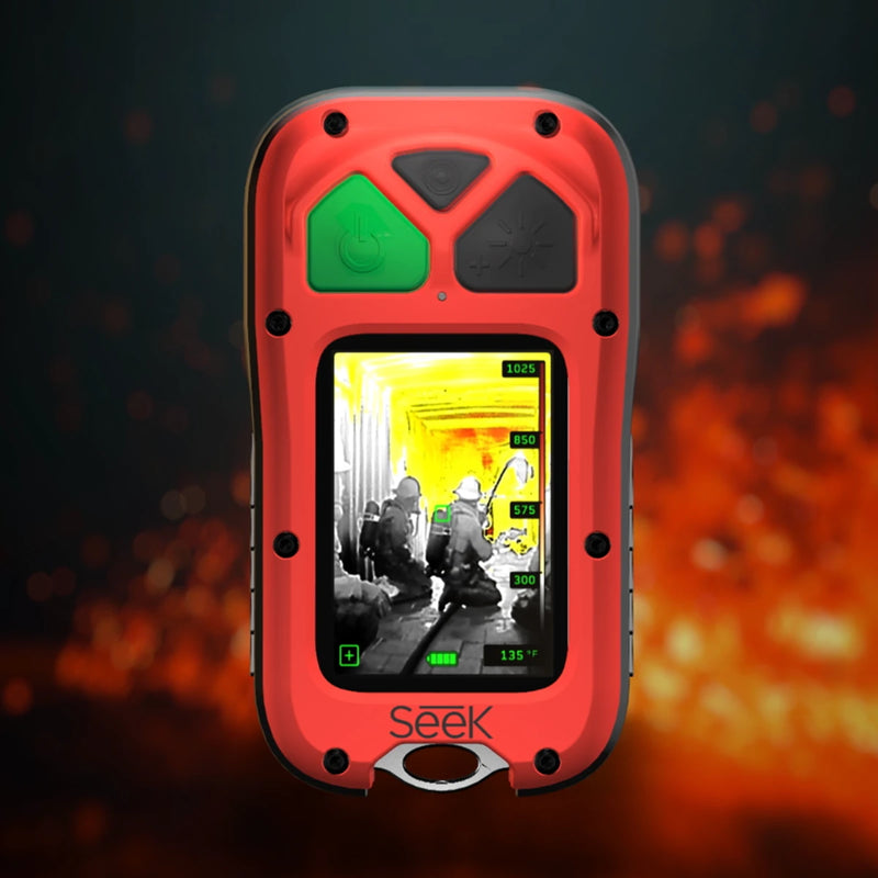 A red and black Seek thermal imaging device with a green power button and a screen showing a thermal view of firefighters, set against a dark background with orange fire-like bokeh.