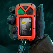 A firefighter holding a red and orange Seek handheld gas detector with a screen showing a gas reading, wearing a black protective glove against a dark, smoky background.