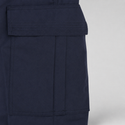 Close-up of a dark navy blue garment showing a large front flap pocket with precise stitching on a light gray background.