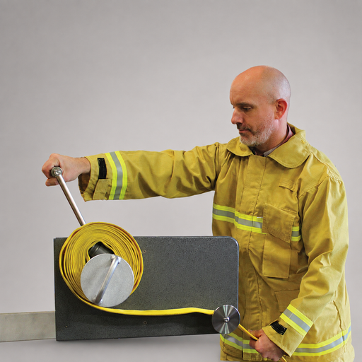 Firefighter using the Cascade hose roller to coil yellow fire hose