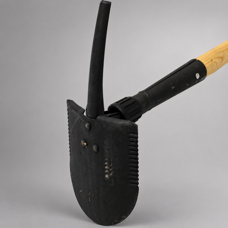 Close-up of Council Tool Combi Tool showing shovel blade, pick and locking mechanism