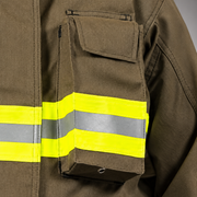 Close-up of the INNOTEX RDG20 coat’s left-chest radio pocket with flap closure, mic loop and reflective trim.