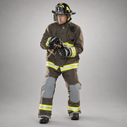 Firefighter wearing khaki INNOTEX RDG20 turnout pants with gray knee reinforcements and reflective leg trim, paired with a matching coat