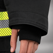 INNOTEX RDG50 coat lower pocket with flap and pull tab above segmented lime-yellow and silver reflective trim.