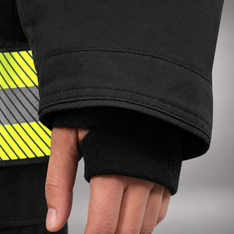 INNOTEX RDG50 coat lower pocket with flap and pull tab above segmented lime-yellow and silver reflective trim.
