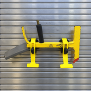 Two PAC Toolok HD mounts securing a yellow Halligan tool horizontally to a metal apparatus panel