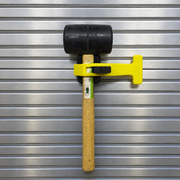 Yellow PAC Toolok HD strap securing a rubber mallet vertically to a metal apparatus panel