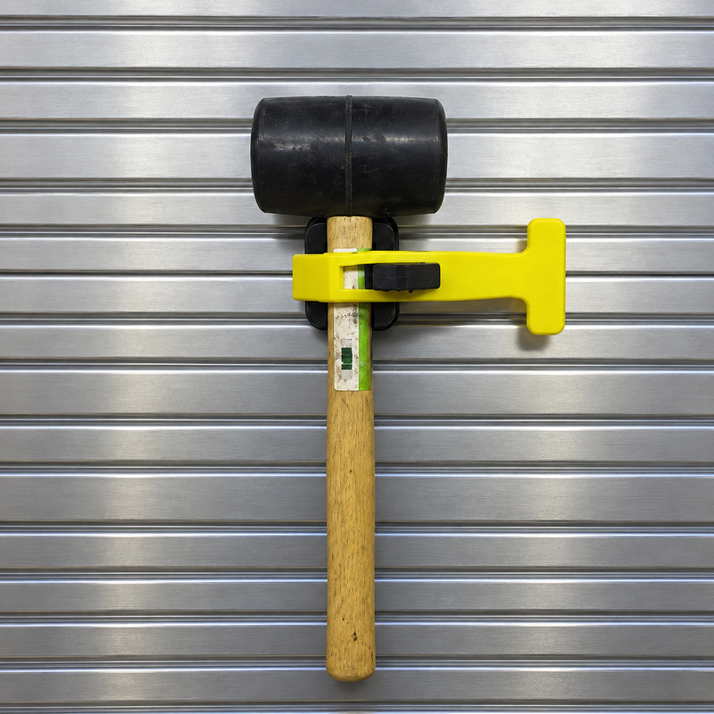 Yellow PAC Toolok HD strap securing a rubber mallet vertically to a metal apparatus panel
