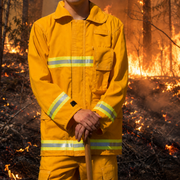 Wildland firefighter wearing Strike Team Tecasafe Plus brush coat with reflective trim during fire operations