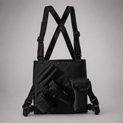 A black tactical shoulder bag with adjustable straps, a front utility pocket, and attached pouches, photographed against a neutral gray background.