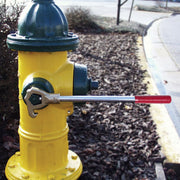 Cascade fire hydrant wrench installed on a yellow fire hydrant