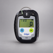 Dräger Pac 6000 CO single-gas detector on a warm gray studio background