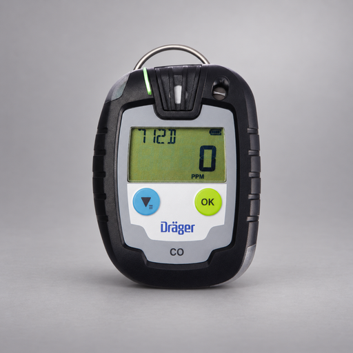 Dräger Pac 6000 CO single-gas detector on a warm gray studio background