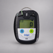 Dräger Pac 6500 CO single-gas detector on a warm gray studio background