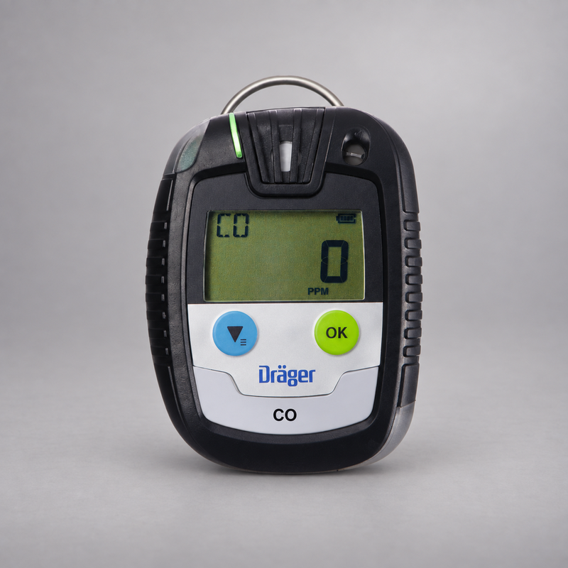 Dräger Pac 6500 CO single-gas detector on a warm gray studio background