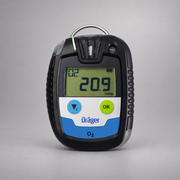 Dräger Pac 6500 O2 single-gas detector on a warm gray studio background