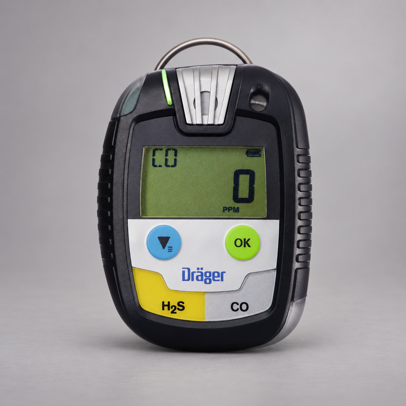 Dräger Pac 8500 H2S and CO dual-gas detector on a warm gray studio background