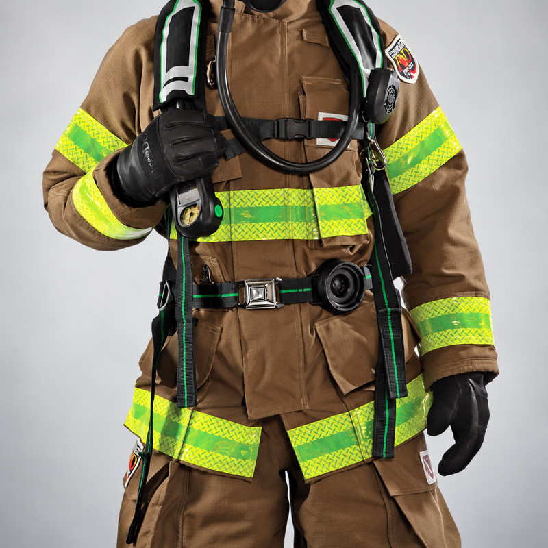 Firefighter wearing Fire-Dex Dex-Pro gloves and turnout gear on a soft gray studio background