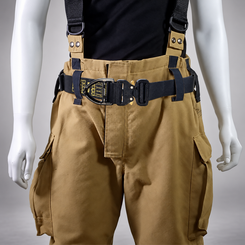 Front view of the Fire Innovations Cree NFPA Escape and Ladder Belt worn over tan turnout pants, showing the buckle and attachment hardware.