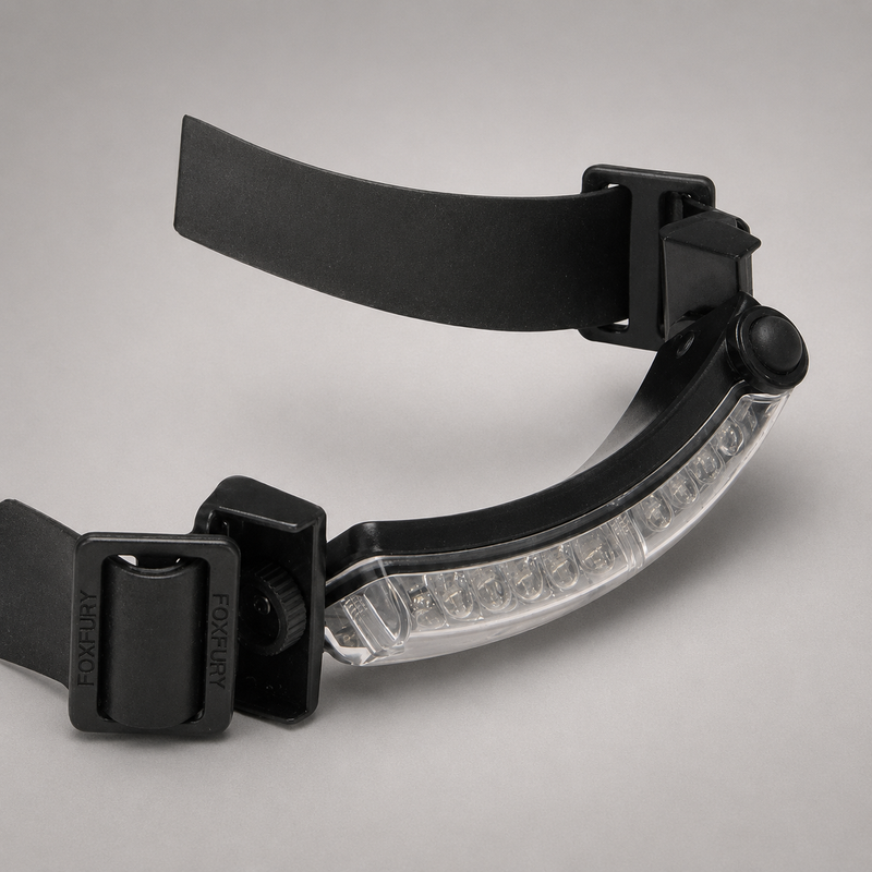 A black Foxfury headlamp with a clear LED light bar, shown on a neutral gray background.