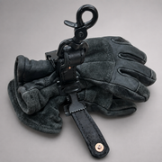 A pair of black leather and suede gloves with a black metal snap hook and strap accessory, displayed on a neutral gray background.