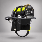 Black MSA Cairns 1836 fire helmet with clear Defender visor, black Nomex earlaps, carved eagle front holder and lime-yellow Scotchlite trim