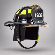 Black MSA Cairns 1836 fire helmet with clear Defender visor, black Nomex earlaps and carved eagle front holder