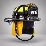 Black MSA Cairns 1836 fire helmet with clear Defender visor, yellow Nomex earlaps and silkscreen eagle front holder