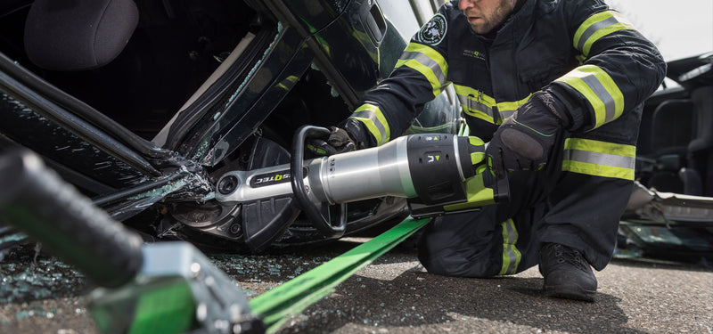 Firefighter using a RESQTEC G-Series EDD cutter during vehicle extrication
