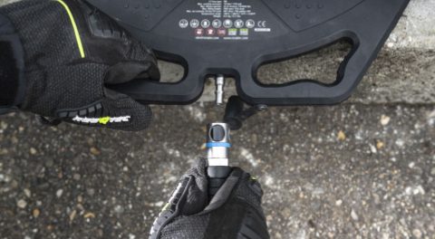 Gloved hand connecting a hose to the protected air inlet on an LT ONE lifting bag