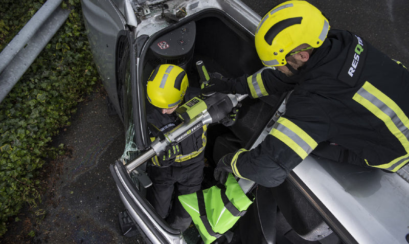 Firefighter positioning a RESQTEC EDD ram inside a vehicle