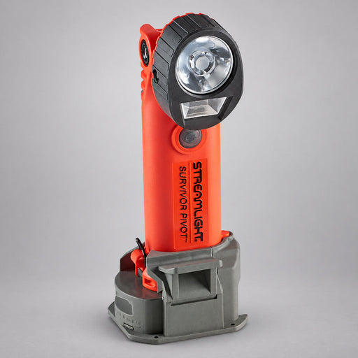 Orange Streamlight Survivor Pivot light pictured in a charging cradle; package contents vary