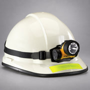 Streamlight Trident headlamp mounted on a white firefighter helmet