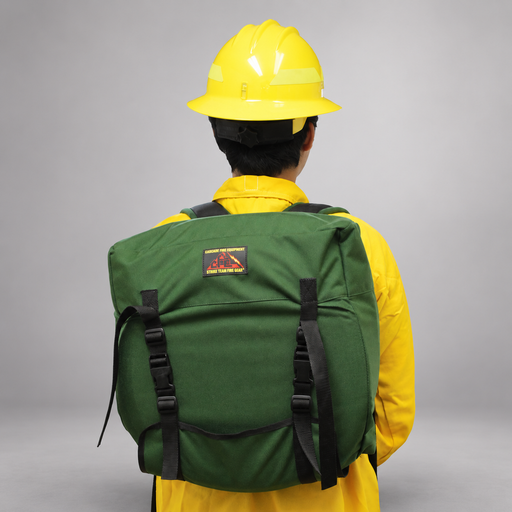 Firefighter wearing the green Strike Team Fed Wildland Hose Pack, showing the protective flap, quick-release buckles and shoulder straps.
