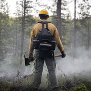 Wildland firefighter wearing a True North Bushwhacker pack in smoky condition