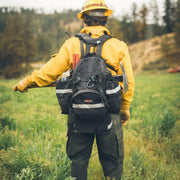 Wildland firefighter wearing a True North Bushwhacker pack in the field