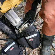 Chainsaw powerhead being placed into the True North Chainsaw Pack carrier