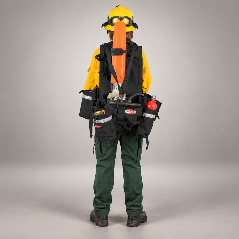 Rear view of a wildland firefighter wearing a True North Chainsaw Pack with chainsaw, storage pouches and equipment bottle