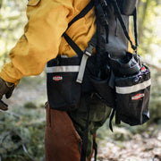 Close-up of True North Chainsaw Pack modular storage pouches worn by a wildland firefighter