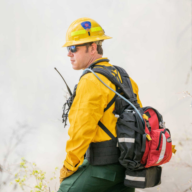Wildland firefighter wearing a red True North Firefly pack