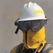 Wildland firefighter wearing ESS Striketeam XTO protective goggles with a white wildland fire helmet and neck shroud