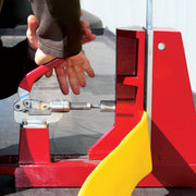Close-up of an operator securing yellow fire hose in the Cascade hose cutter adjustable vise