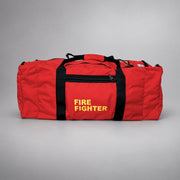 Red Strike Team Deluxe Gear Bag with end cargo pouches, black webbing handles and yellow FIRE FIGHTER lettering.