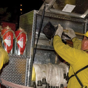 Drip torches stored in brackets inside a fire apparatus compartment