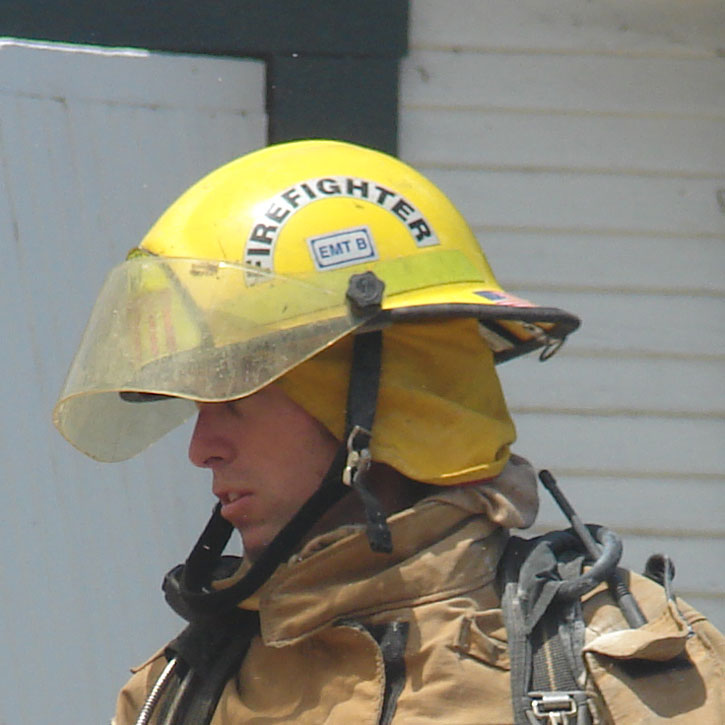 Firefighter helmet crescent with black lettering on a yellow helmet