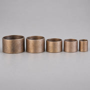 Five red brass hose coupling expansion rings in graduated sizes