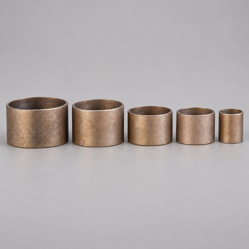 Five red brass hose coupling expansion rings in graduated sizes