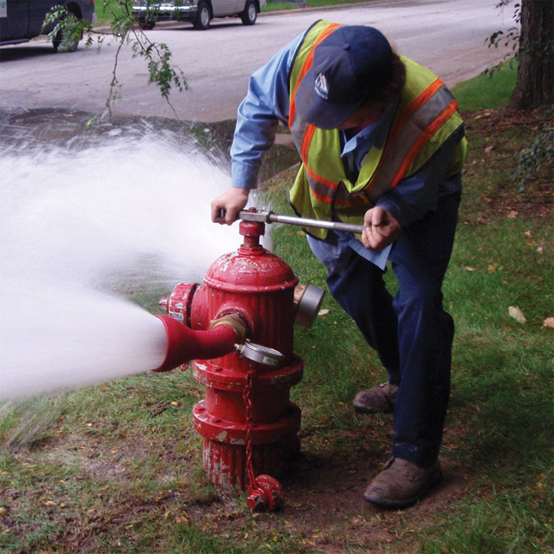 Firefighter operating a hydrant during a fire hose connection