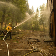 Pressure relief valve installed in a portable fire pump hose line