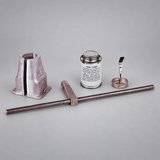 Red Head Brass booster hose installation kit with clamp, key, wrench and Bar Lube on a gray background